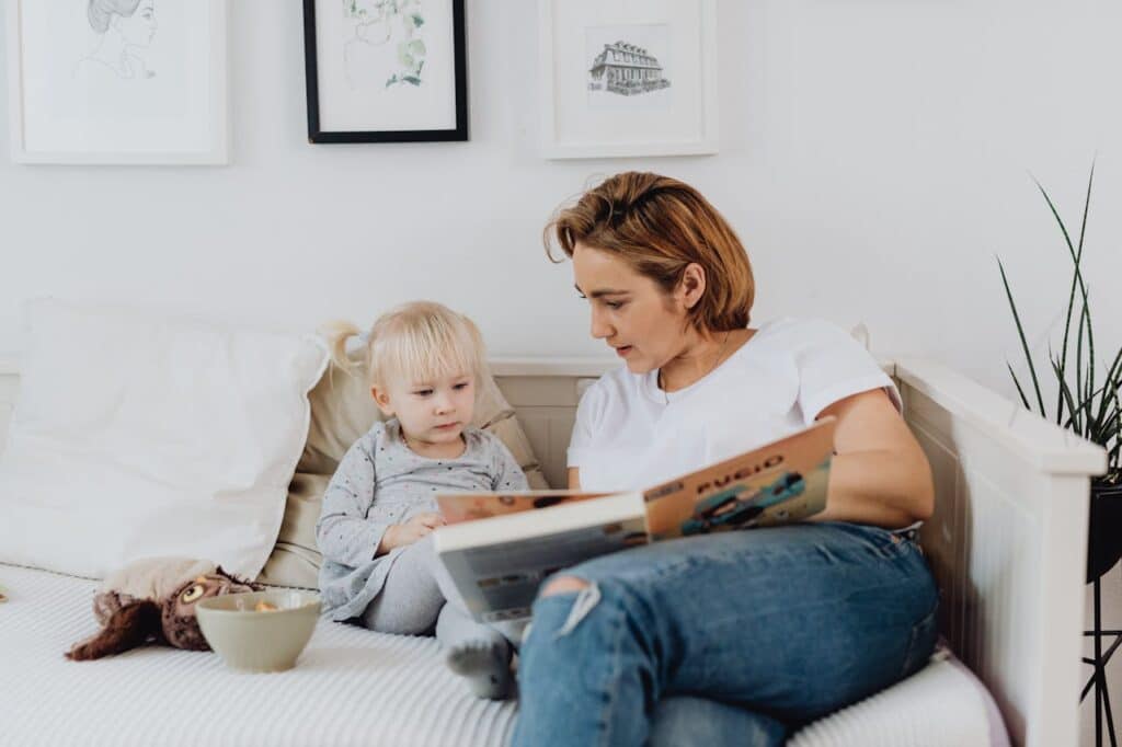 pexels-photo-6274969 Cuentos clásicos para niños; A mother and child share a quiet moment reading a book on a cozy couch. Perfect for family and lifestyle themes.
